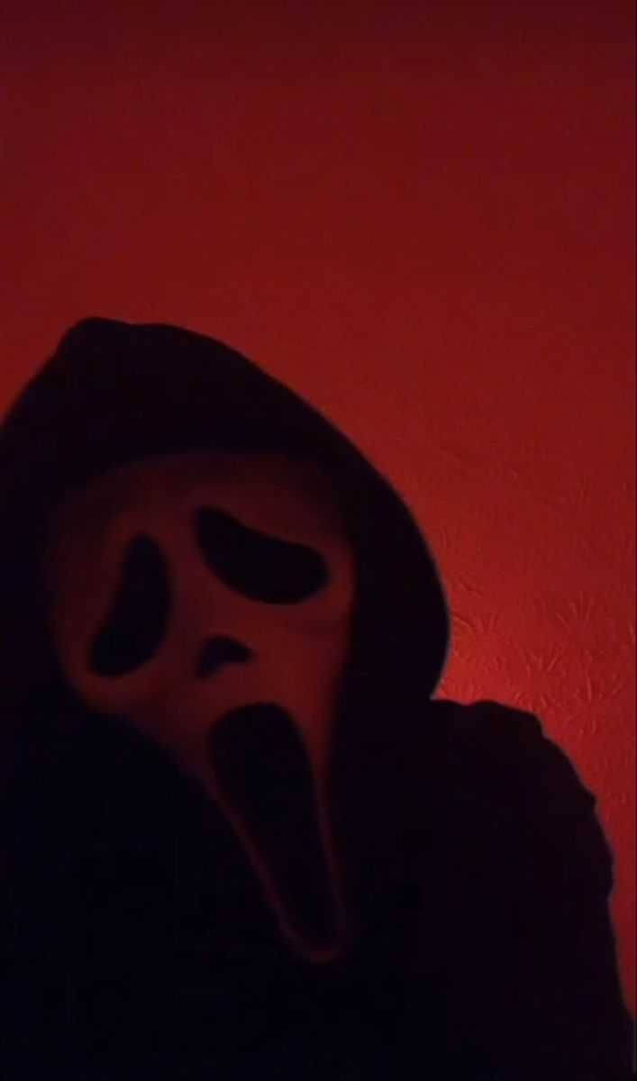 Foreboding Image Of Ghostface In A Red Room Background