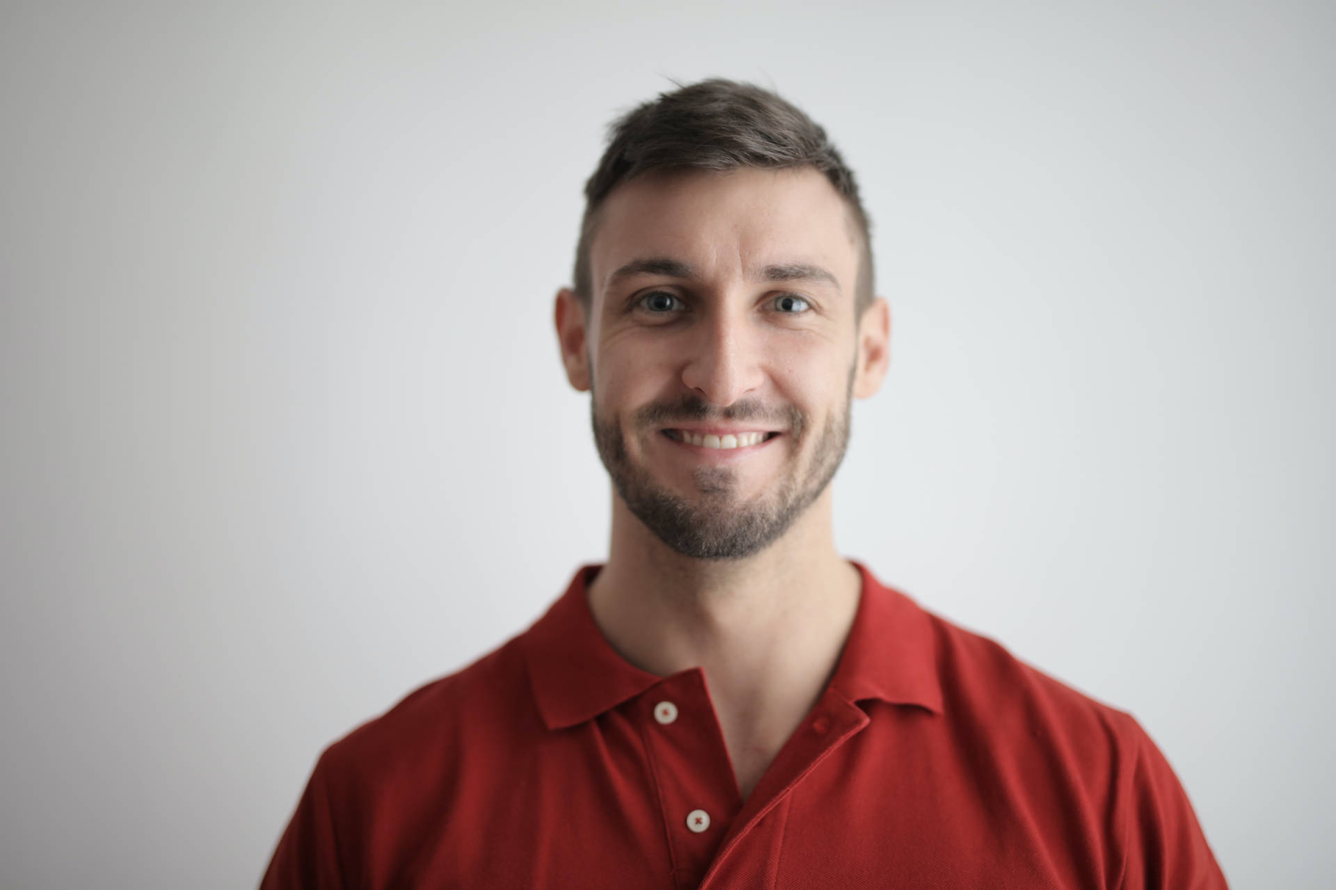 Formal Headshot Of Man Wearing Red Polo