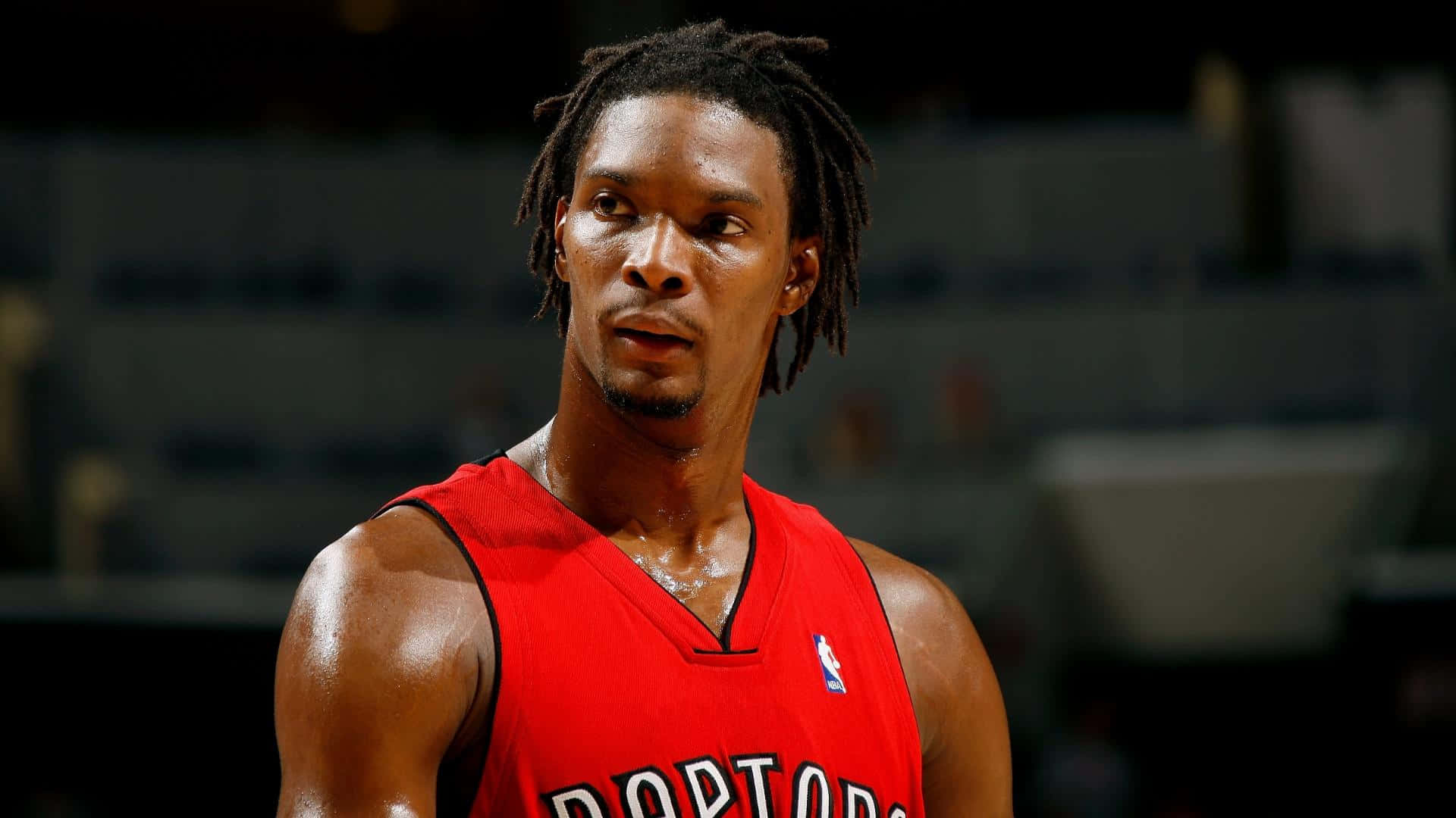 Former American Professional Basketball Player Chris Bosh In Toronto Raptors Background
