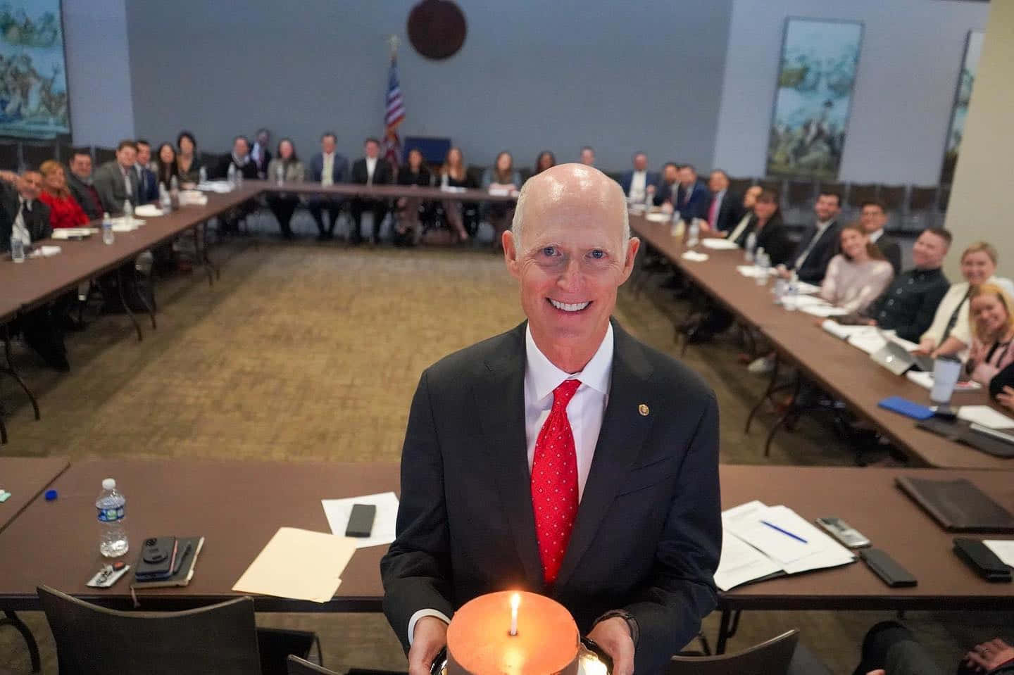 Former Florida Governor Rick Scott, Holding A Cake During A Celebration.