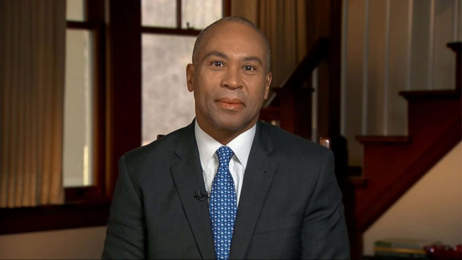 Former Governor Deval Patrick Climbing A Staircase Background