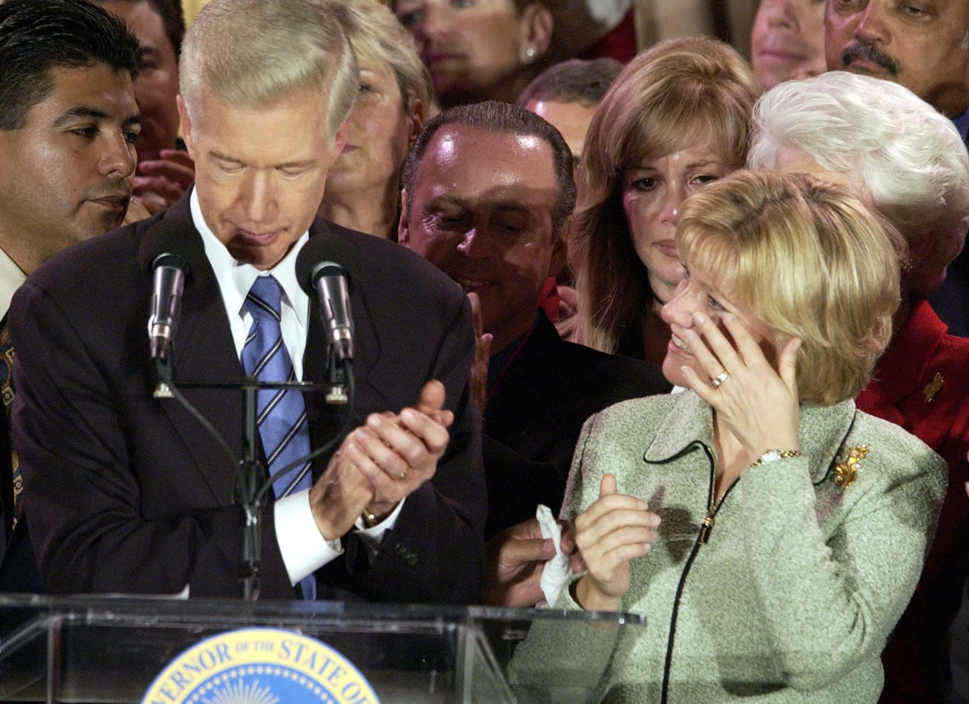 Former Governor Gray Davis Delivering A Speech At The Podium Background