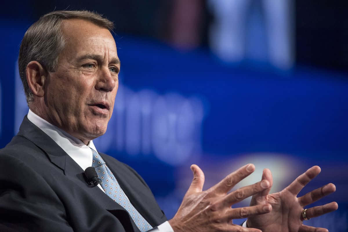 Former House Speaker John Boehner Communicating With Hand Gestures Background