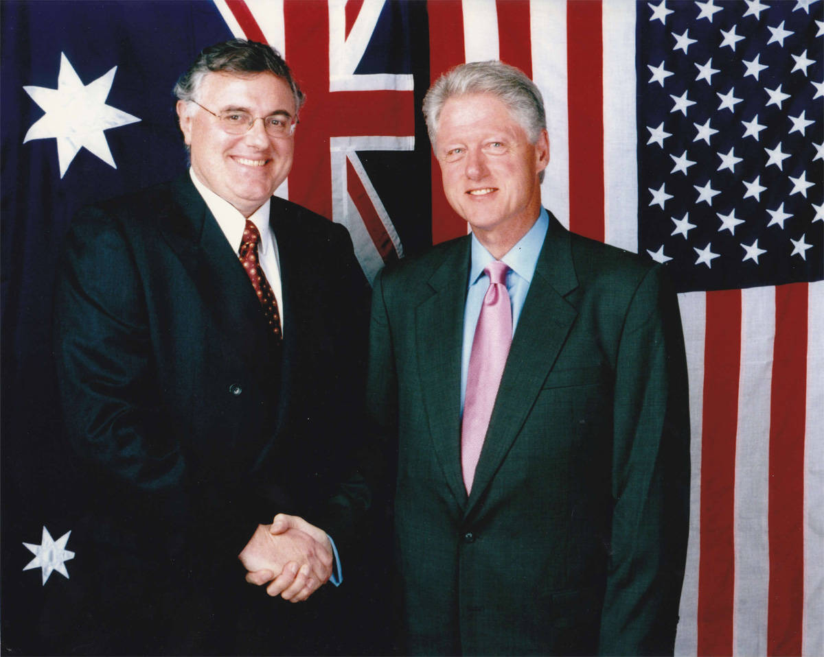 Former President Bill Clinton In A Green Suit Background