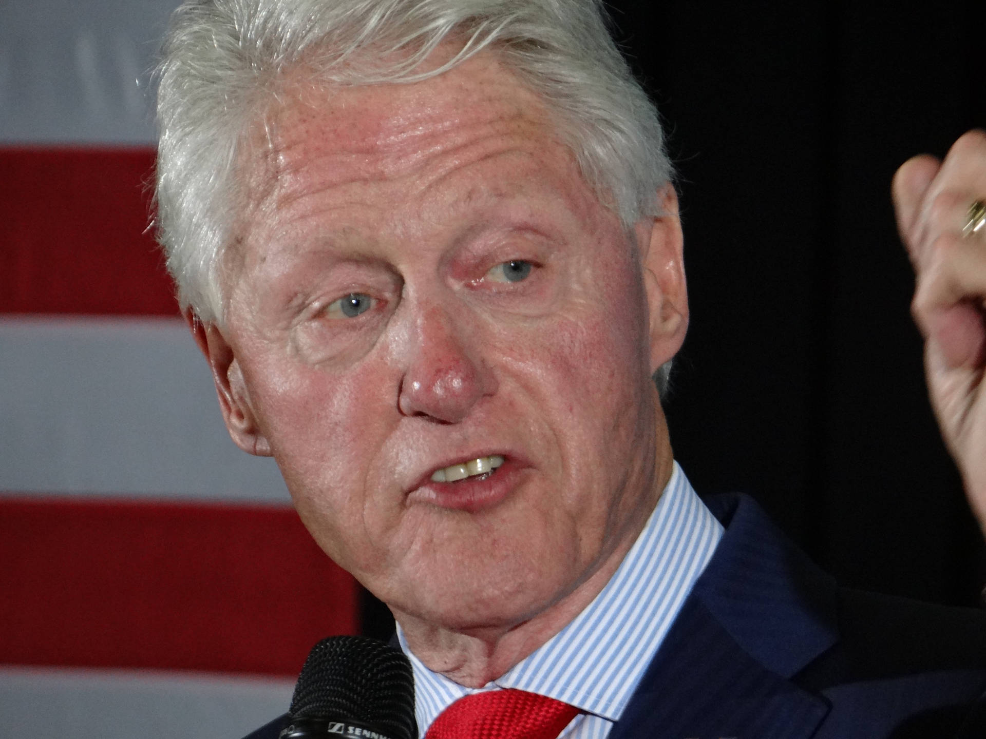 Former President Bill Clinton With A Focused Expression Background