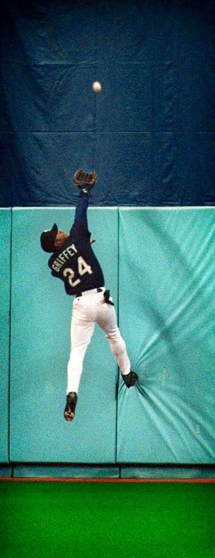 Former Seattle Mariners Superstar Ken Griffey Jr. Crushing A Homerun Background