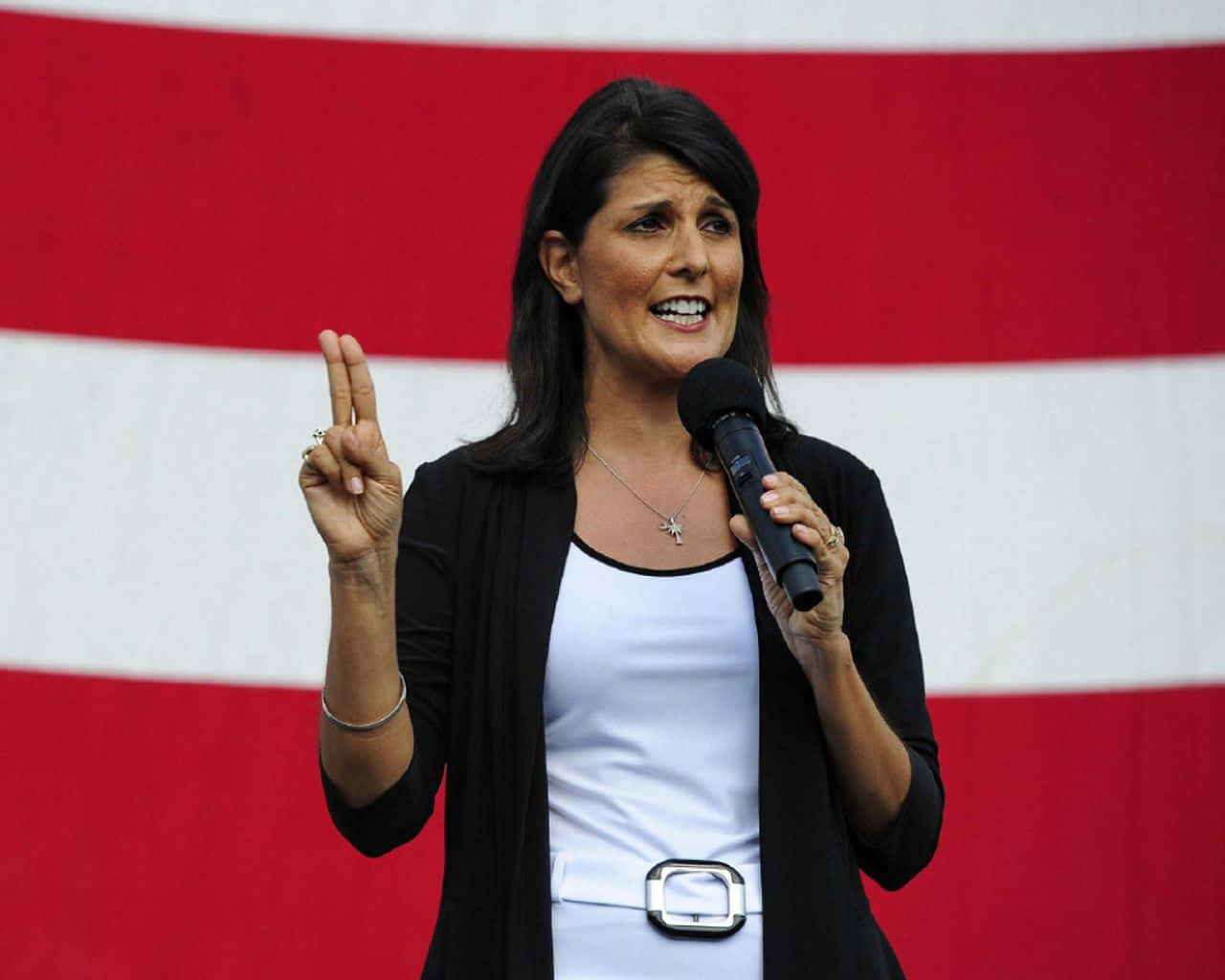 Former U.s Ambassador Nikki Haley Confidently Flashing A Peace Sign Background