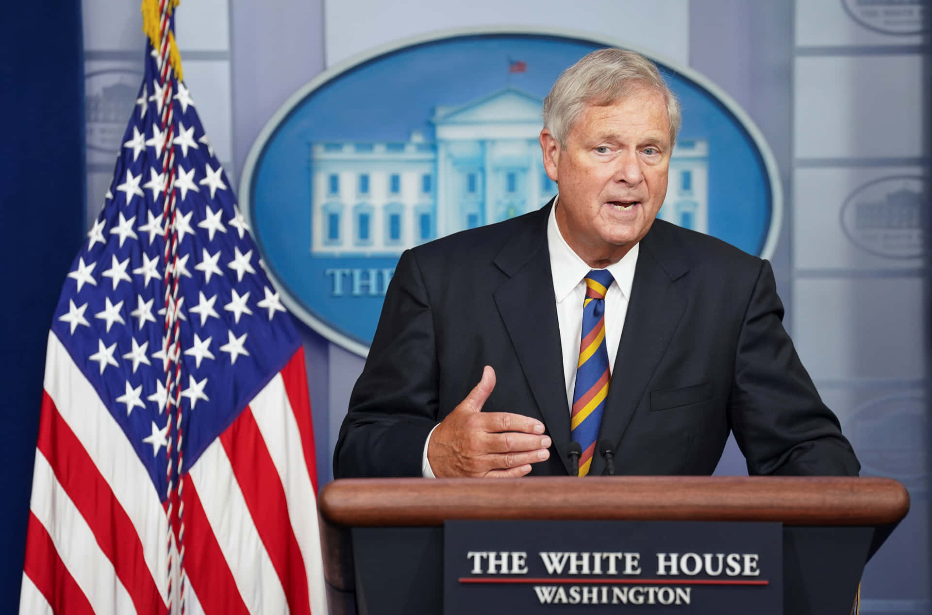 Former United States Secretary Of Agriculture Tom Vilsack Speaking At A Press Conference Background