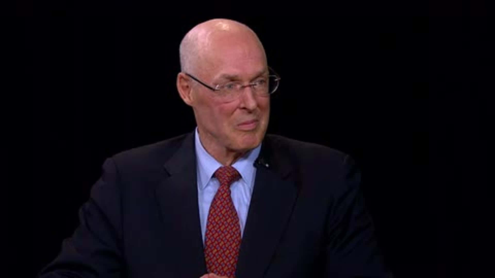 Former Us Treasury Secretary Henry Paulson Smiles During An Interview