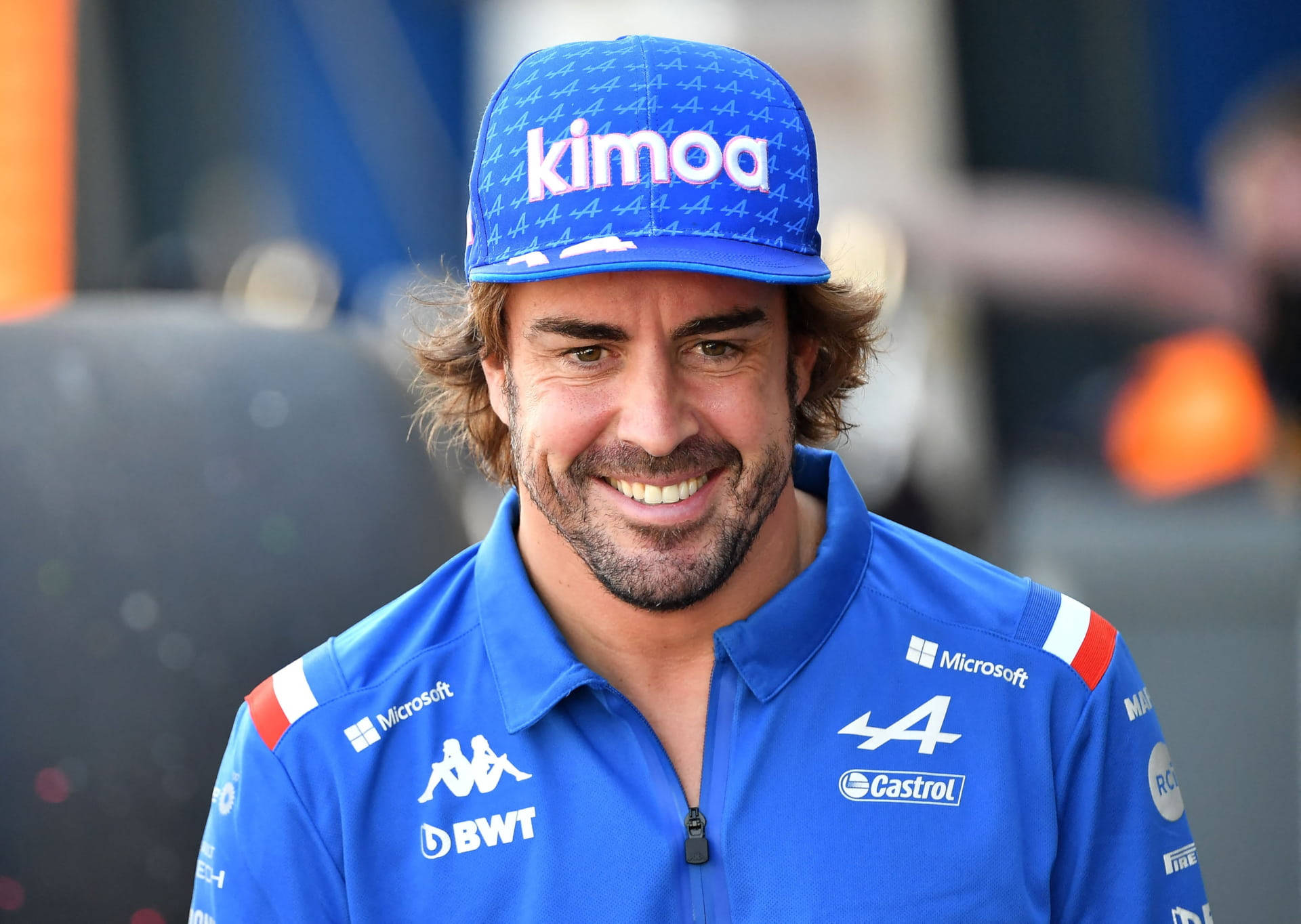 Formula 1 Legend Fernando Alonso In Blue Attire Background