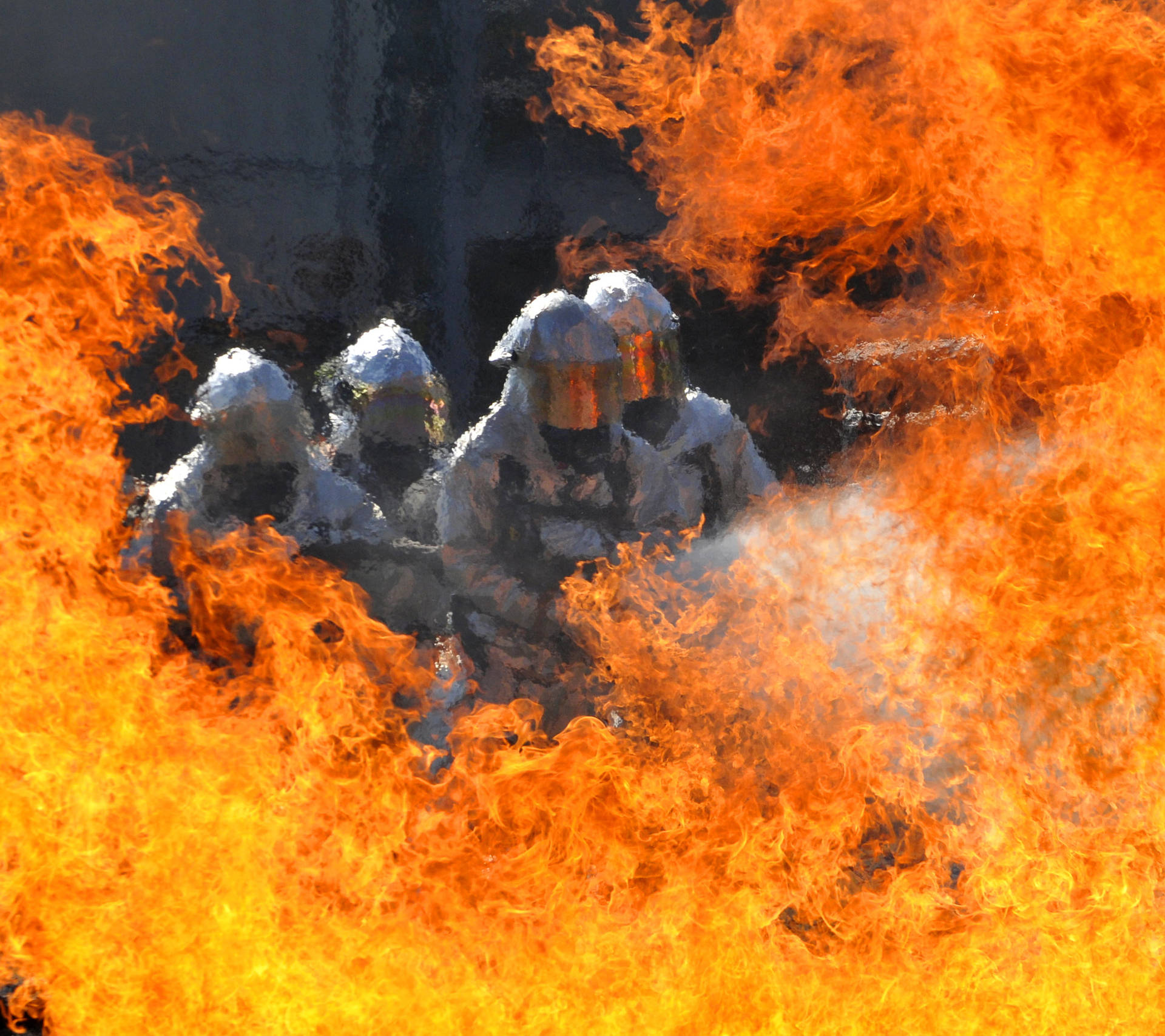 Four Firefighters Putting Out Fire Background