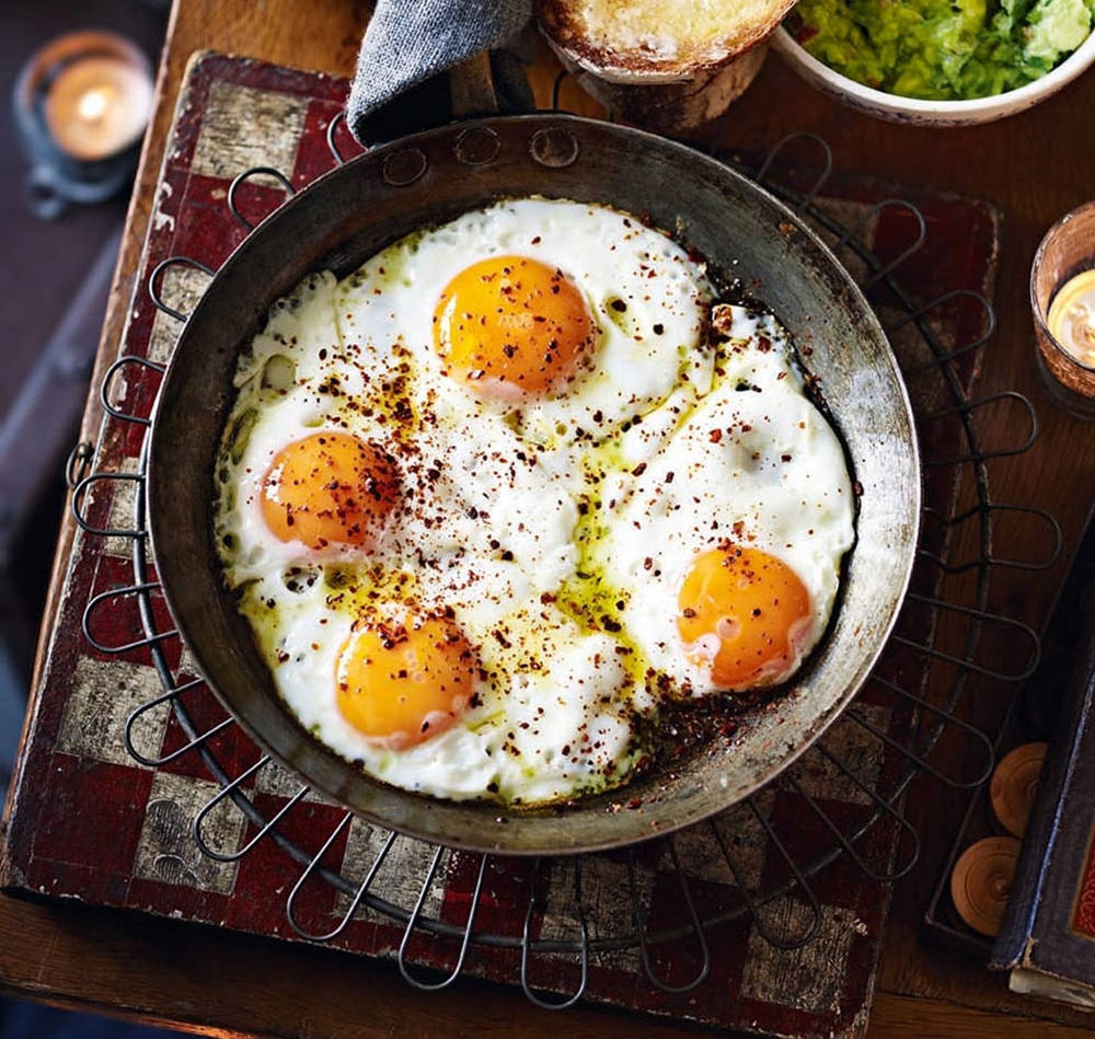 Four Fried Eggs In A Skillet Background