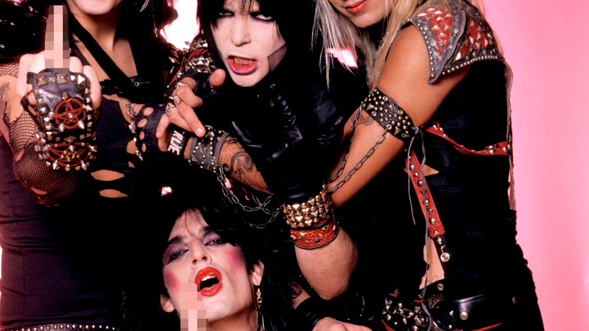 Four Women In Punk Outfits Posing For A Picture Background
