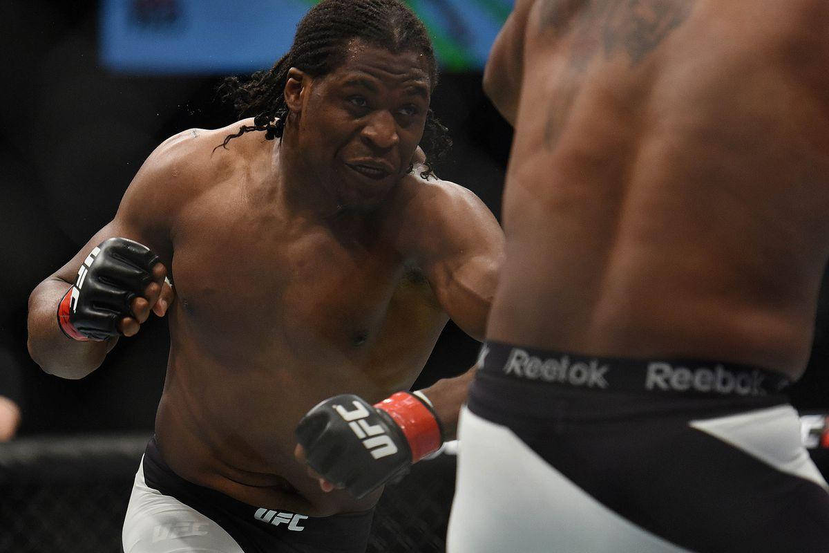 Francis Ngannou Bracing For Action In Octagon Background