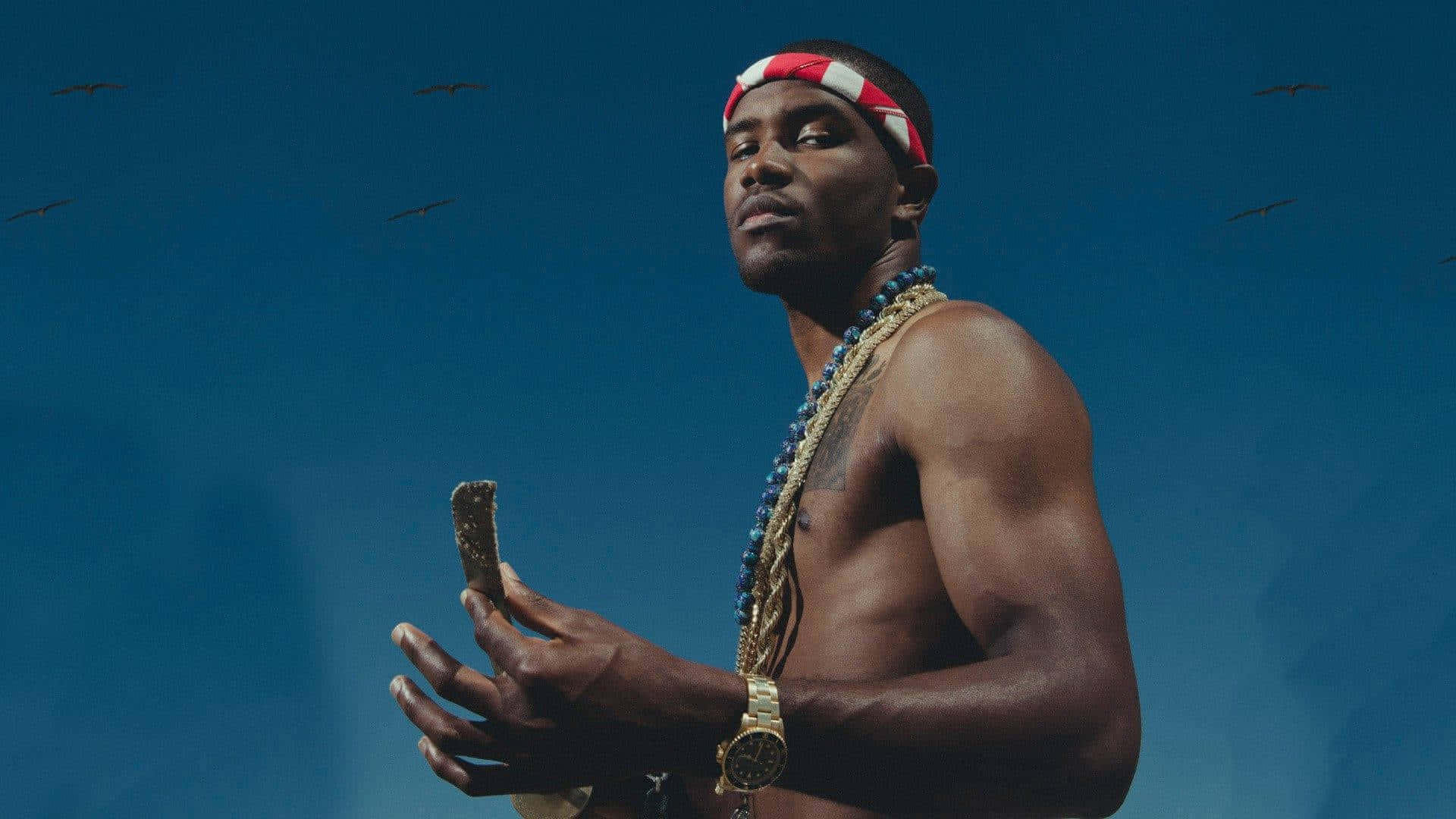 Frank Ocean Typing Away On A Laptop Background