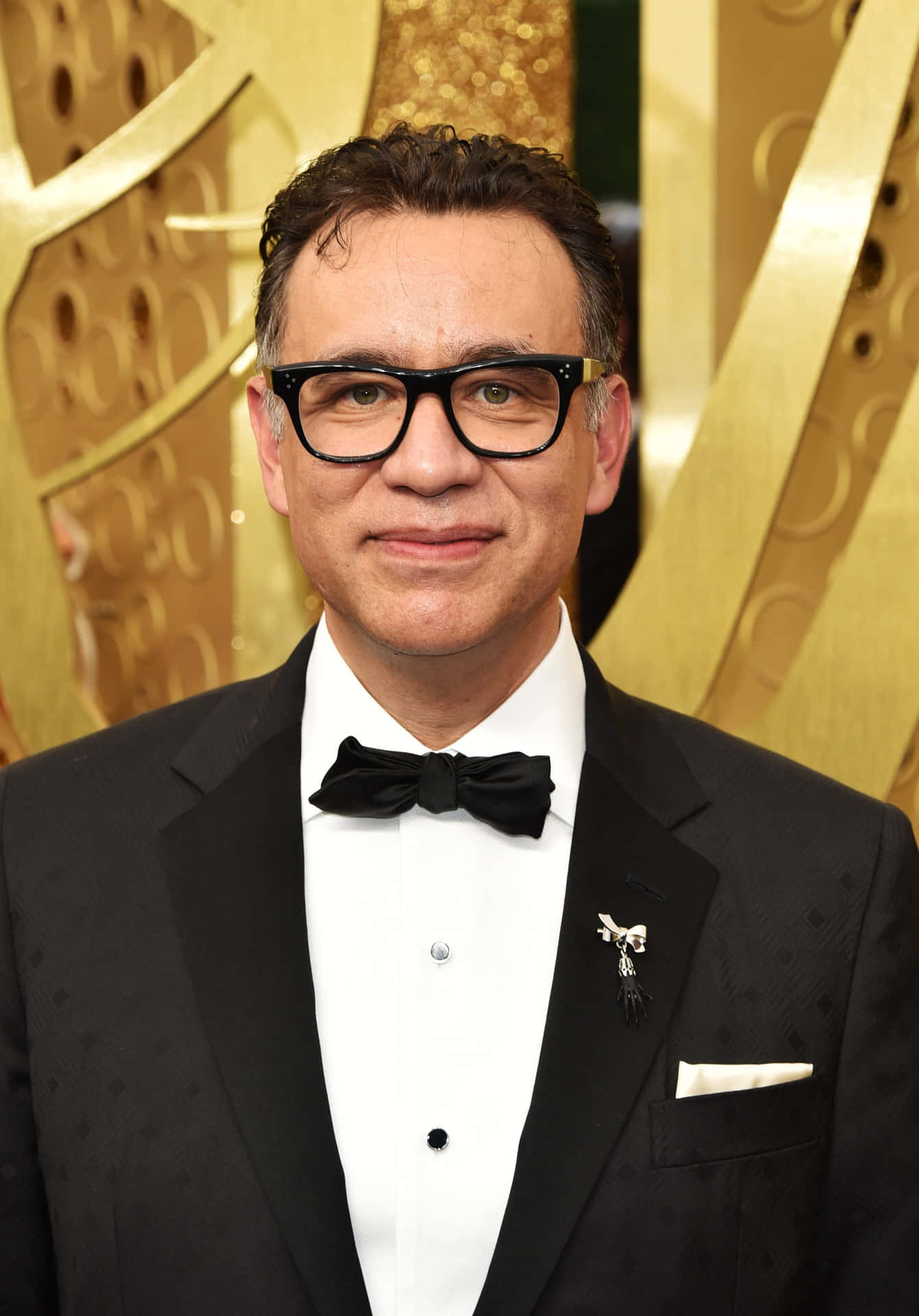 Fred Armisen Delighting With A Comedic Gesture On Stage Background