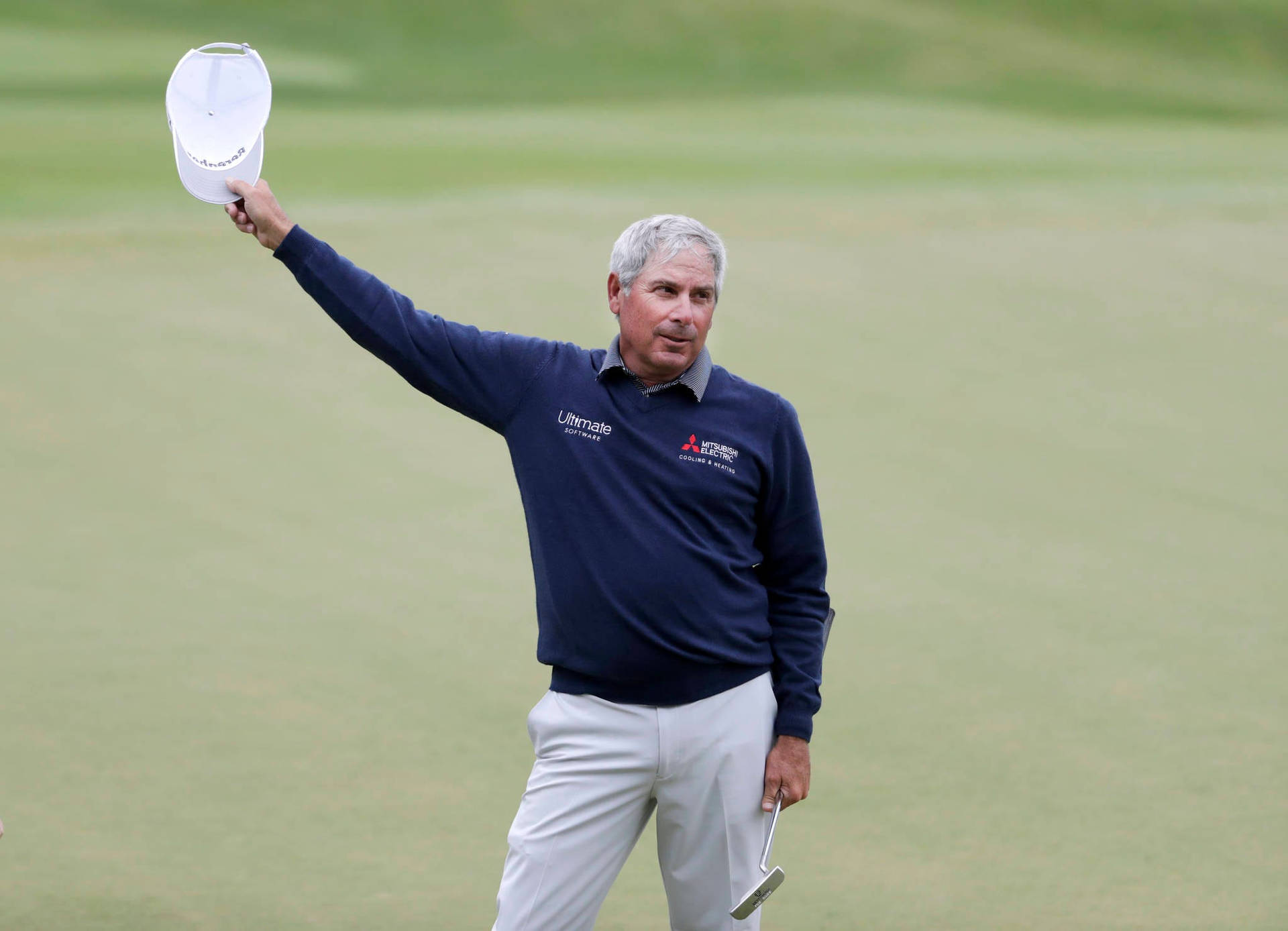 Fred Couples Swinging With Style In A White Cap Background