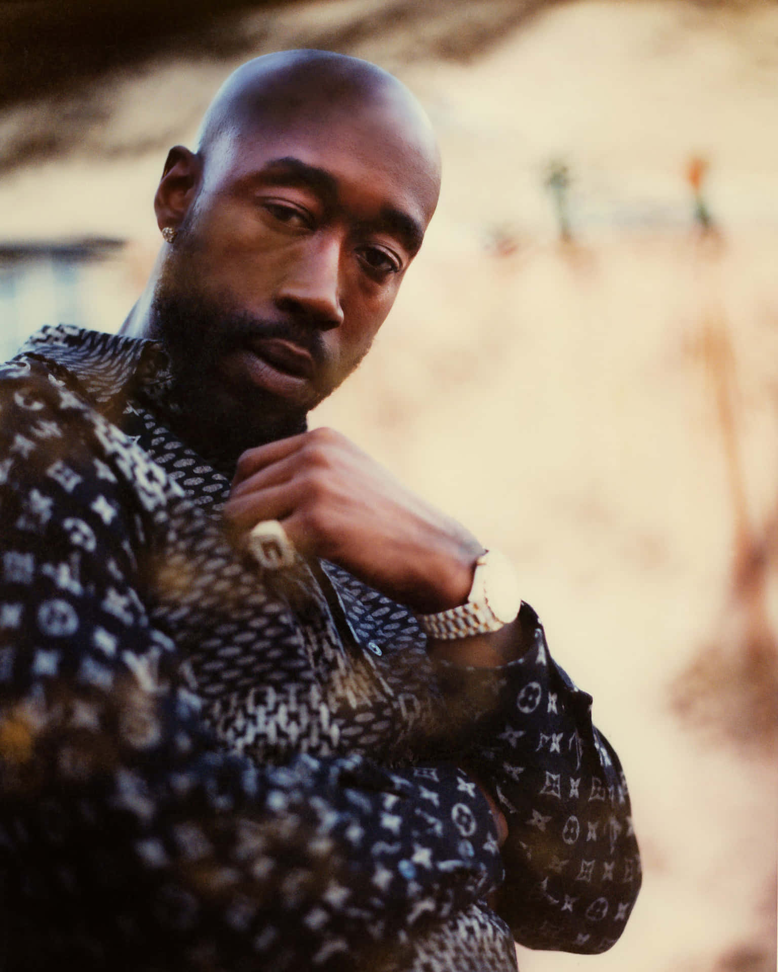 Freddie Gibbs Contemplative Pose Background
