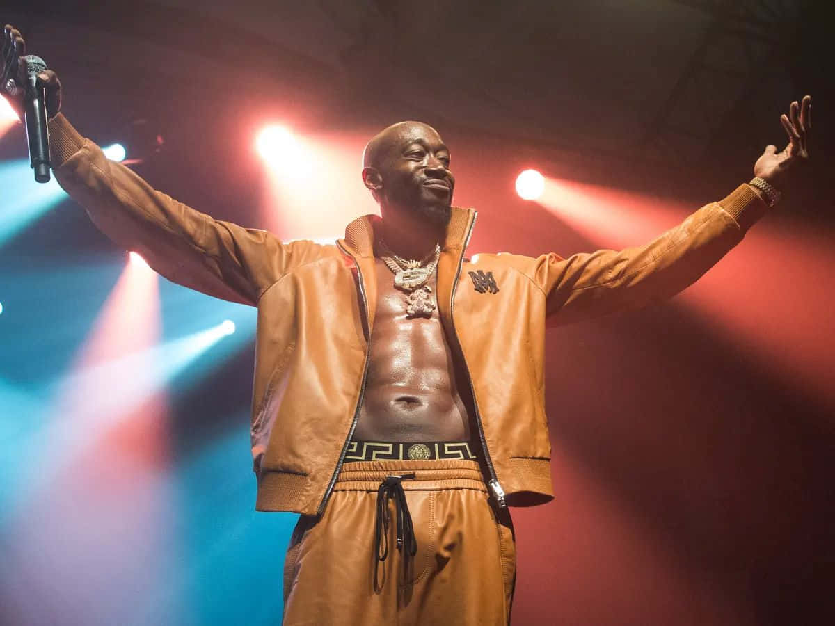 Freddie Gibbs Performingon Stage Background