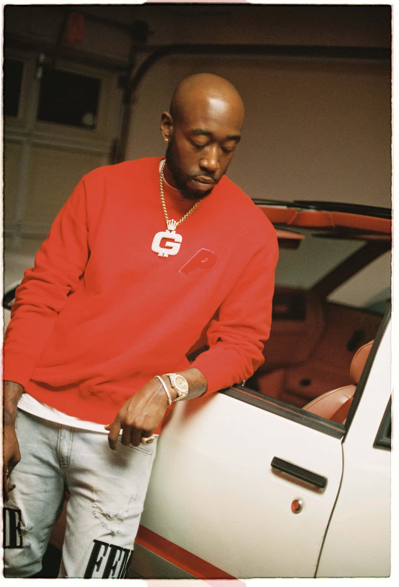 Freddie Gibbs Red Sweater Car Portrait Background