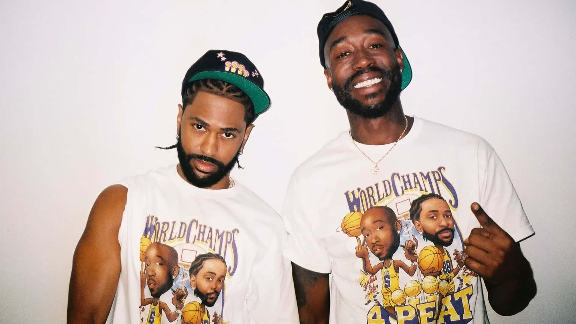 Freddie Gibbsand Friend Wearing World Champs Shirts Background