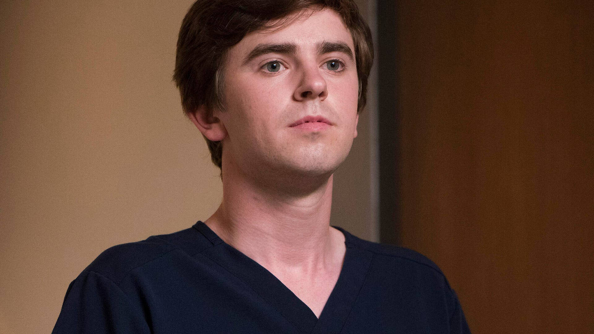 Freddie Highmore Serious Face Background