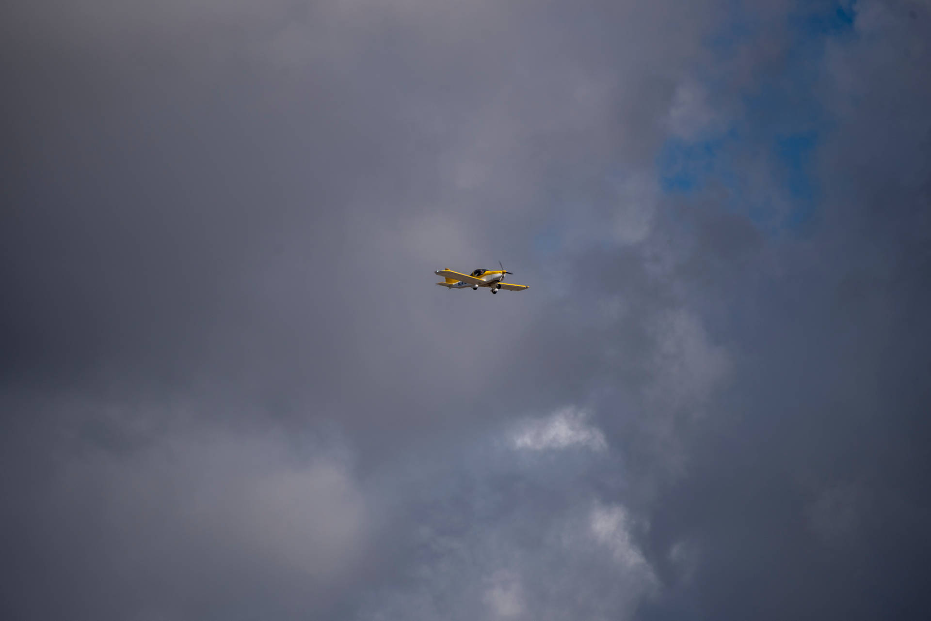 Freedom In The Sky: Small Yellow Plane Soaring High Background