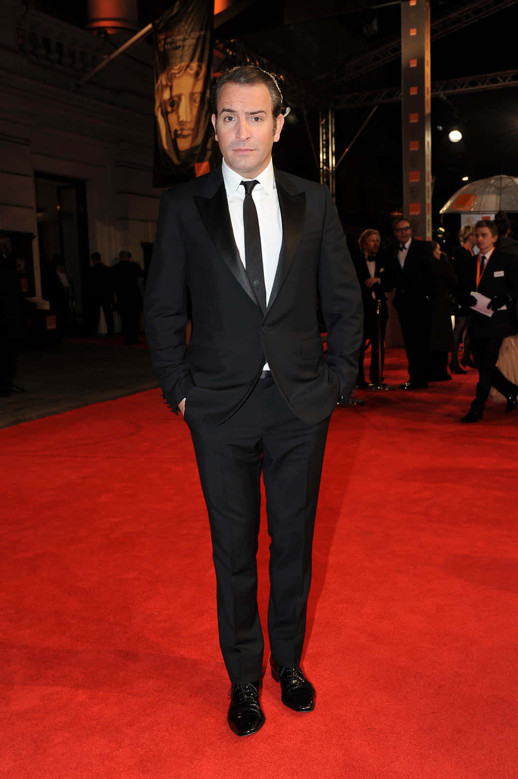 French Actor Jean Dujardin In Formal Attire Background