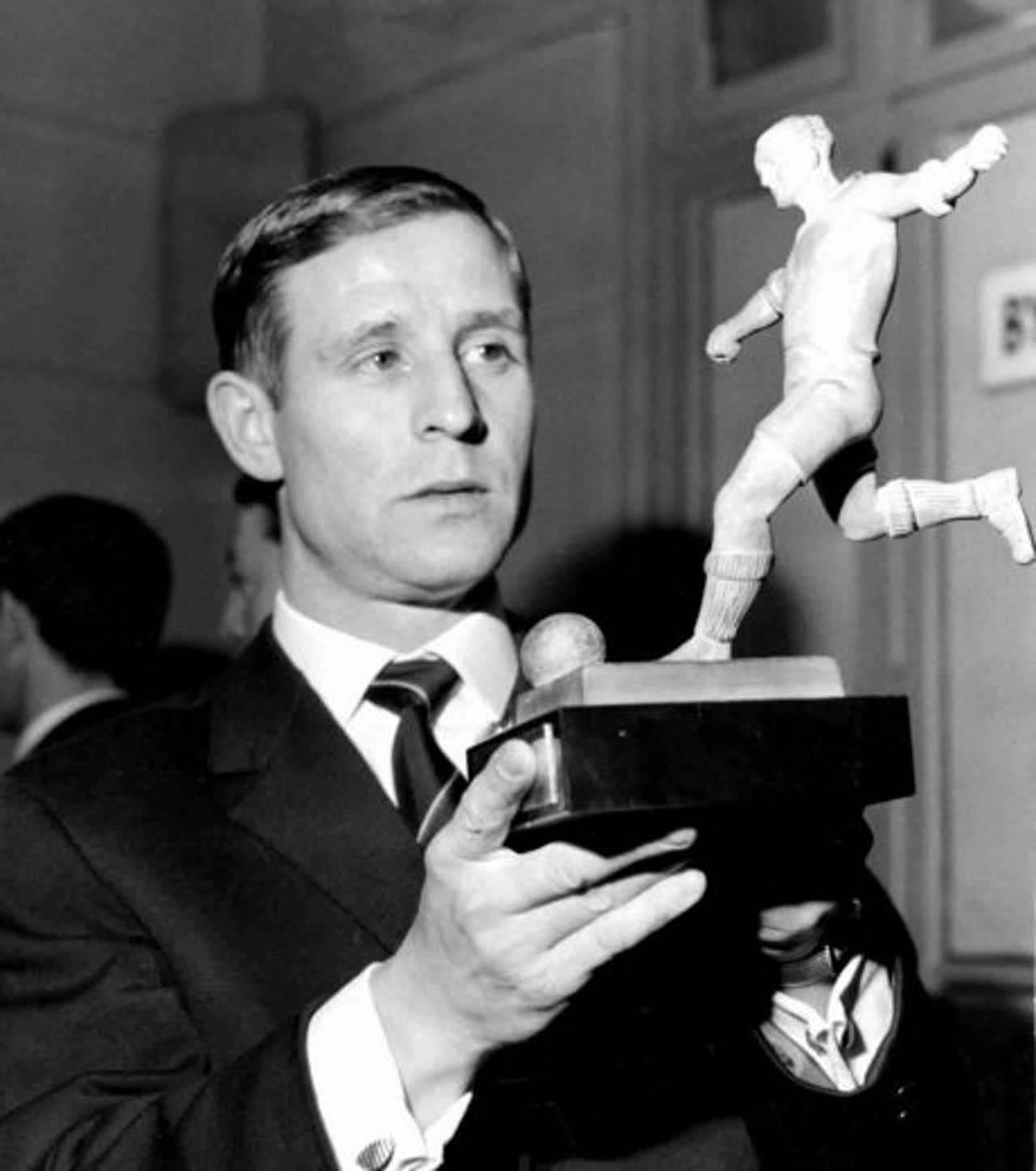 French Footballer Raymond Kopa Holding A Football Trophy Background