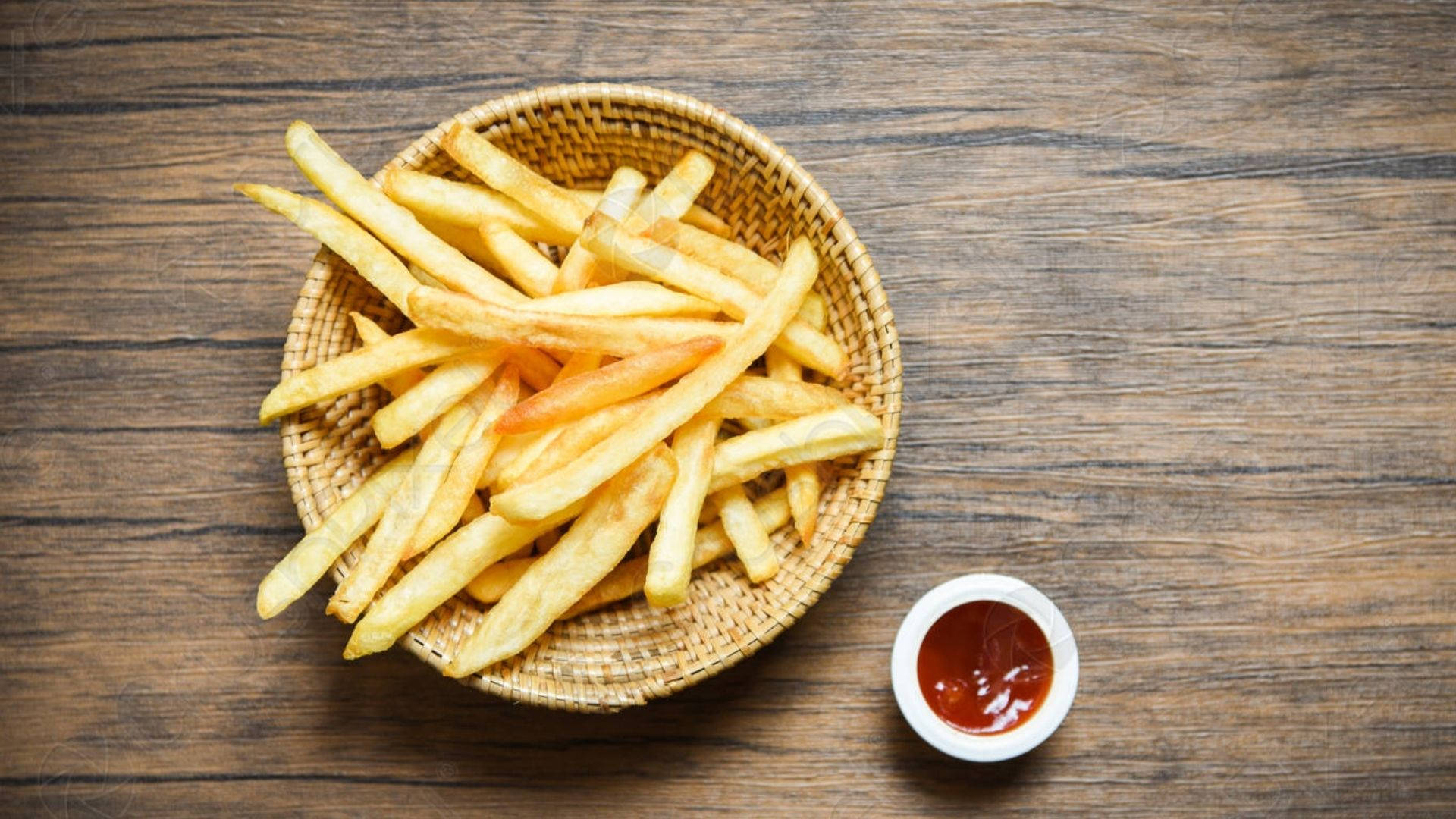 French Fries On A Wooden Plate Background