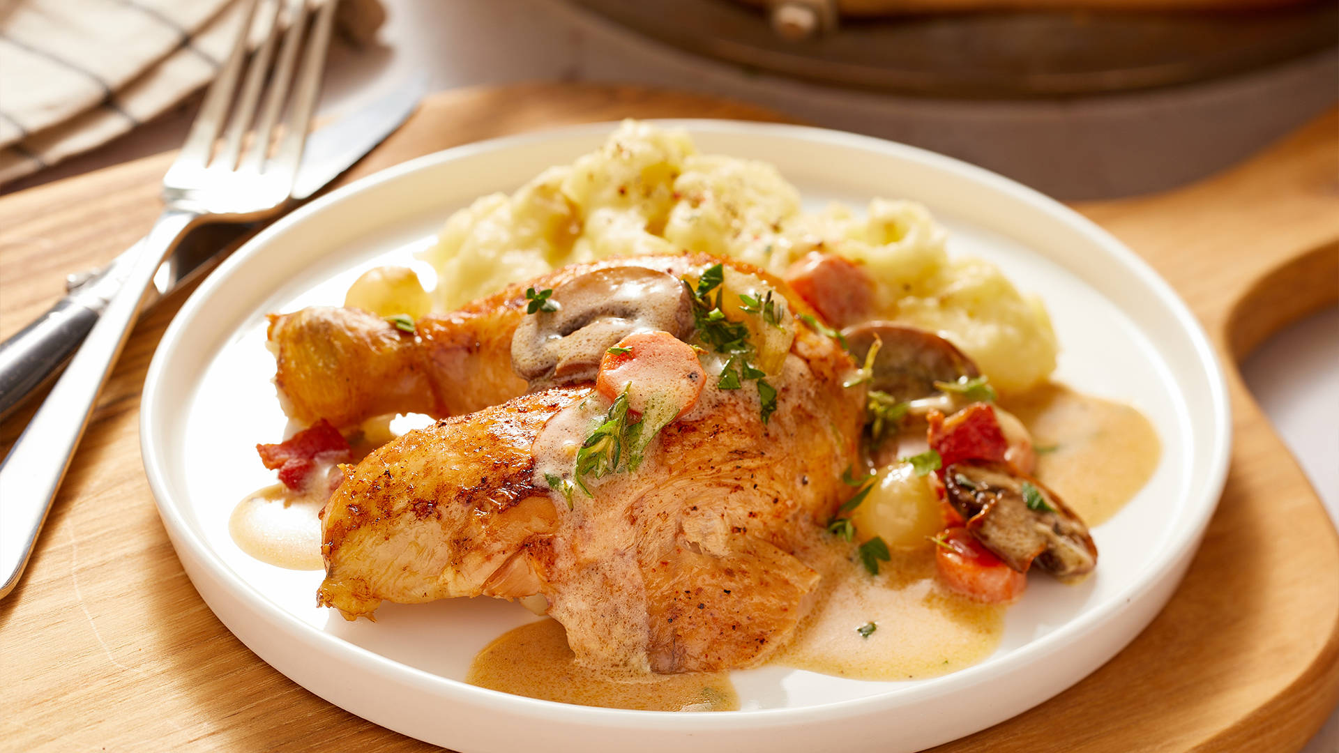 French Gourmet Delight, Coq Au Vin, Beautifully Plated On A White Ceramic Dish Background