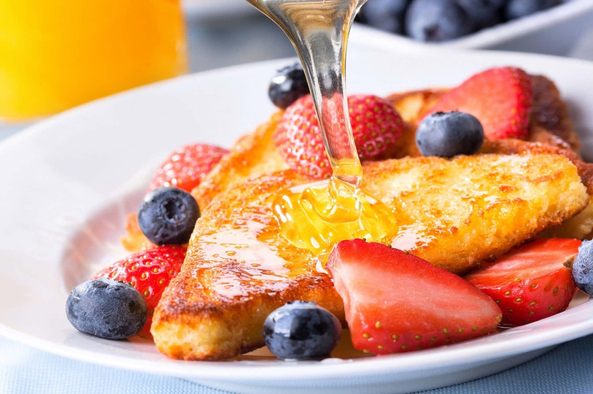 French Toastwith Berriesand Honey Drizzle Background