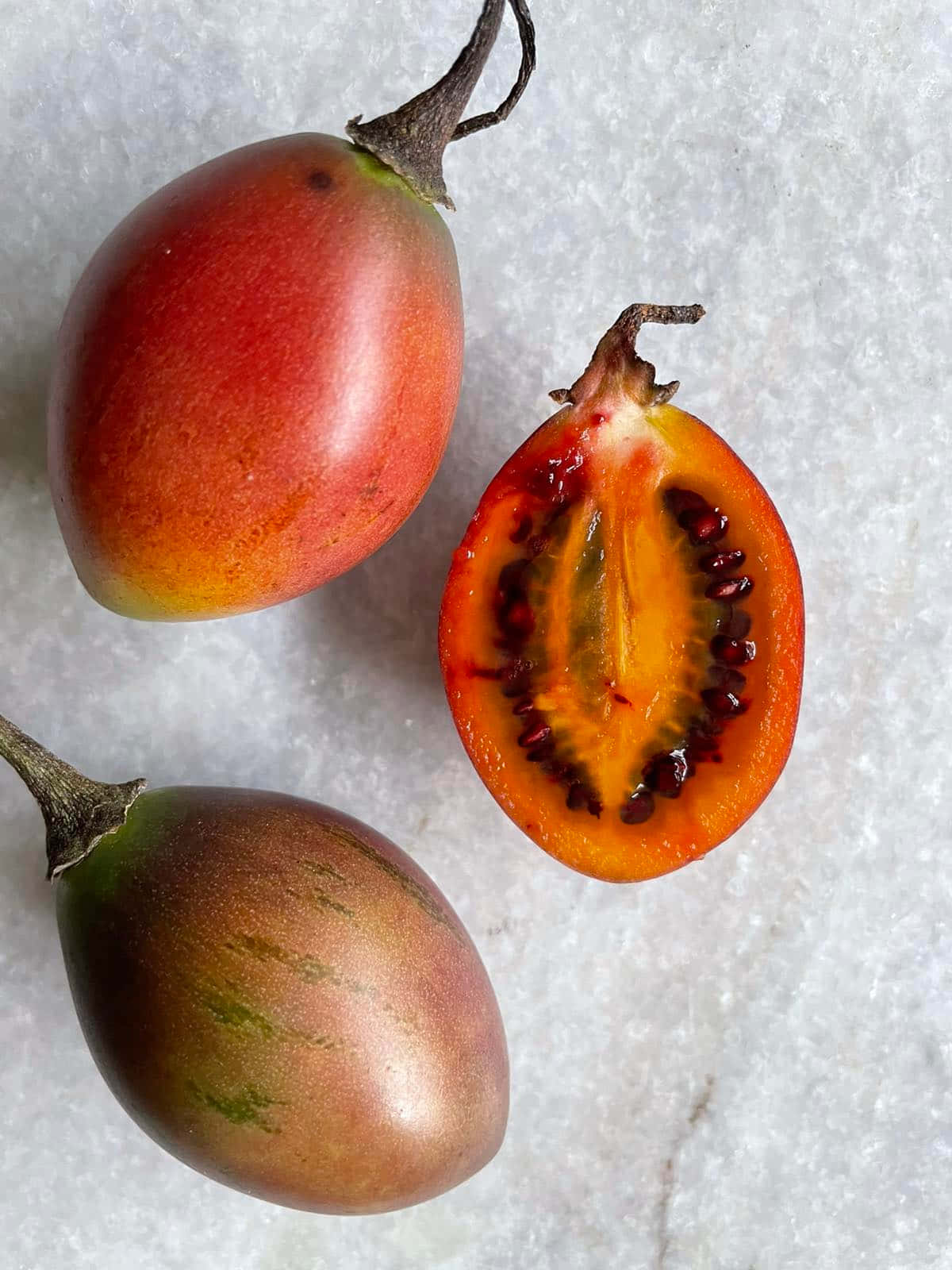 Fresh And Vibrant Tamarillo Trio Background