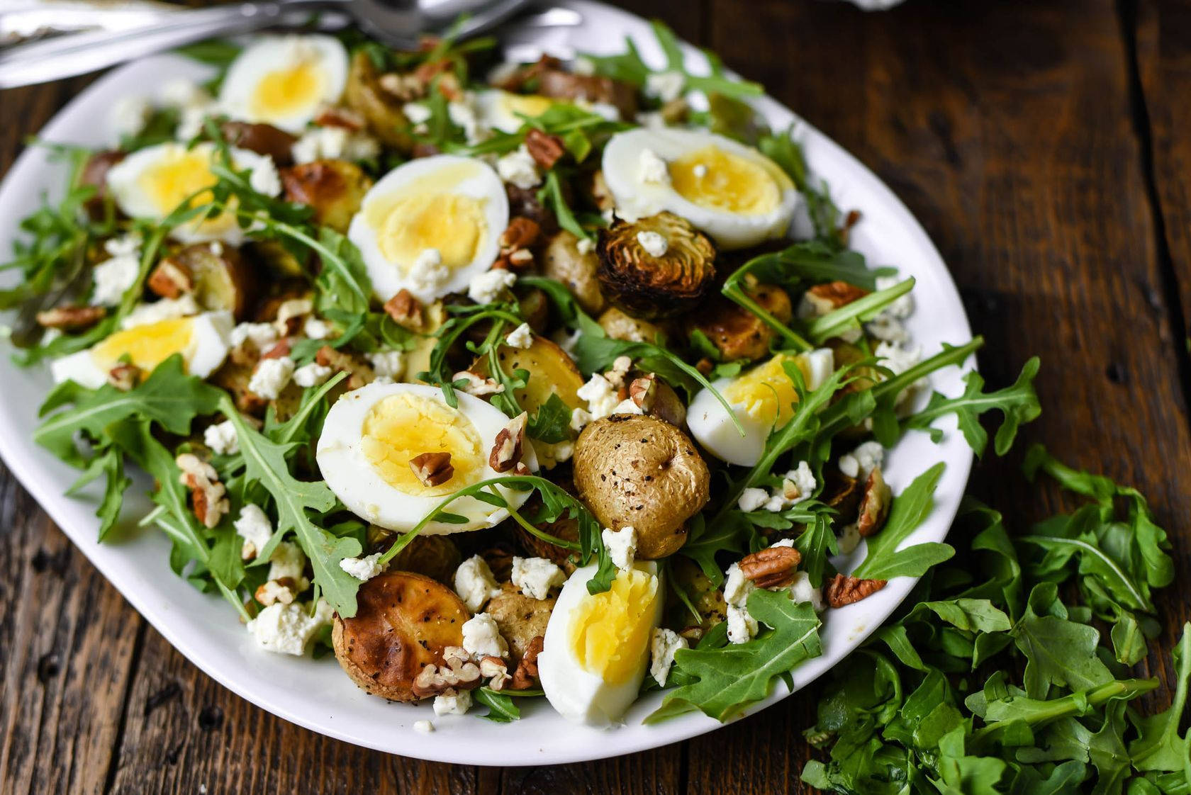 Fresh Arugula, Eggs, And Potatoes Salad On A Rustic Table