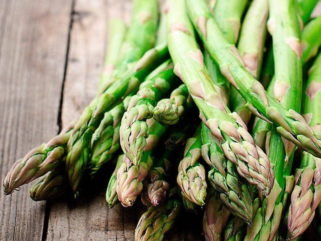 Fresh Asparagus With Pointy Brown Leaves Background