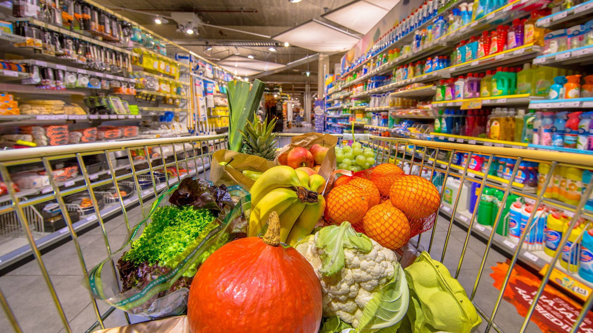 Fresh Assortment Of Fruits And Vegetables In Grocery Store Background