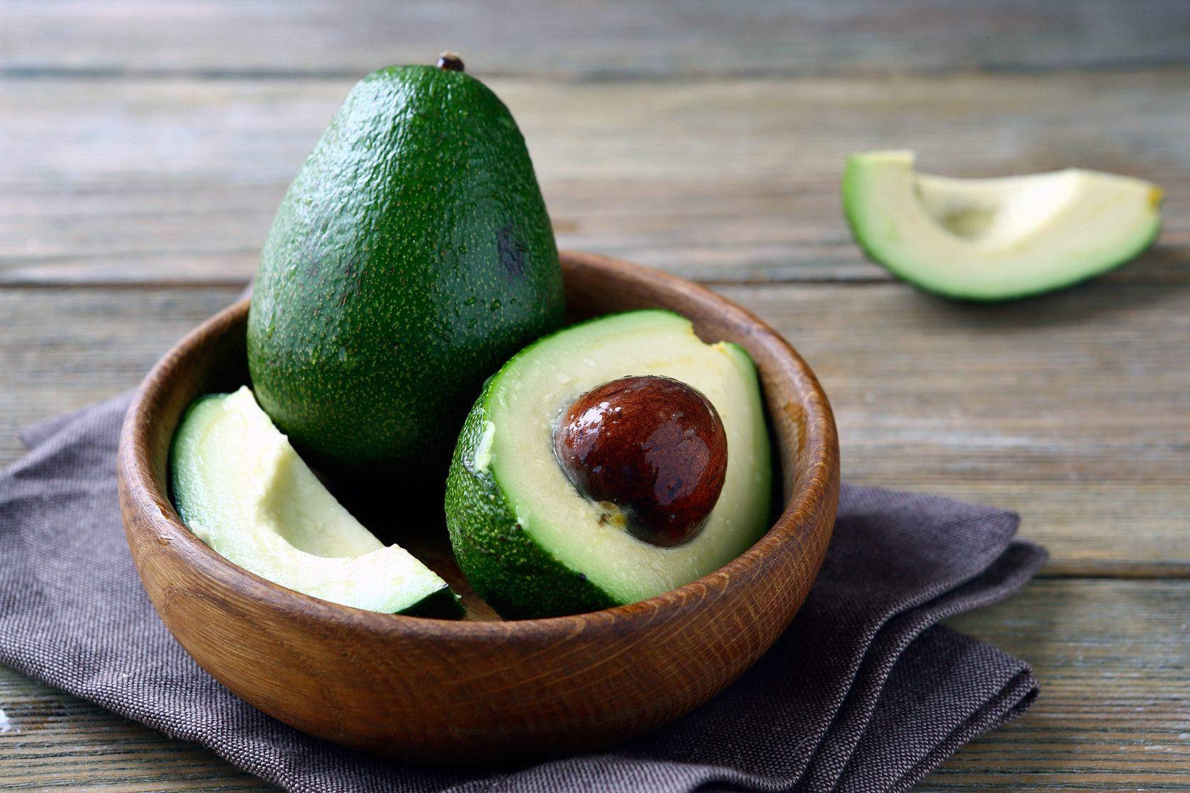 Fresh Avocado Fruit On Wooden Plate