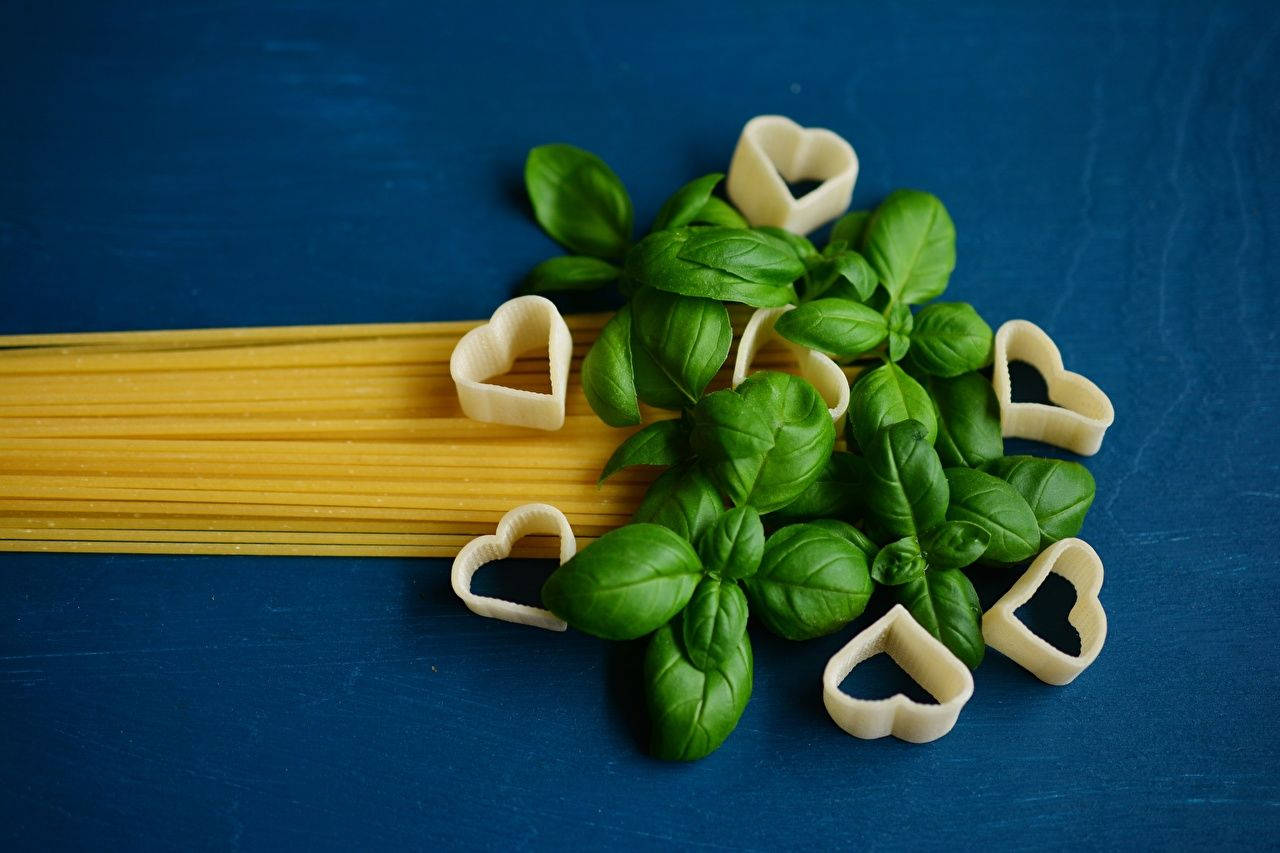 Fresh Basil Leaves With Spaghetti Pasta In A Kitchen Setting Background