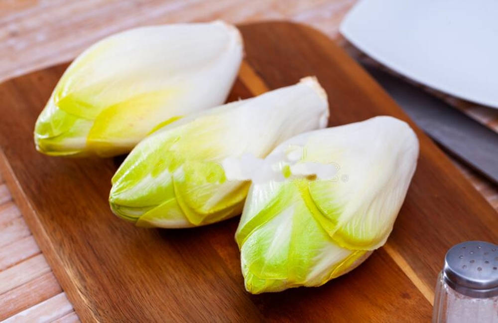 Fresh Belgian Endive Vegetables On A Wooden Board Background