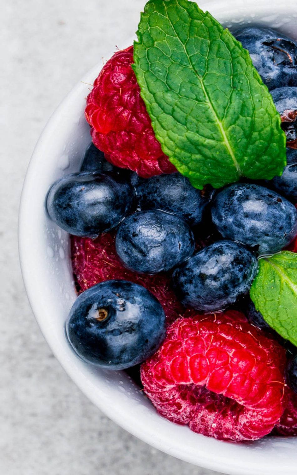 Fresh Blueberries And Raspberries In A Ceramic Bowl