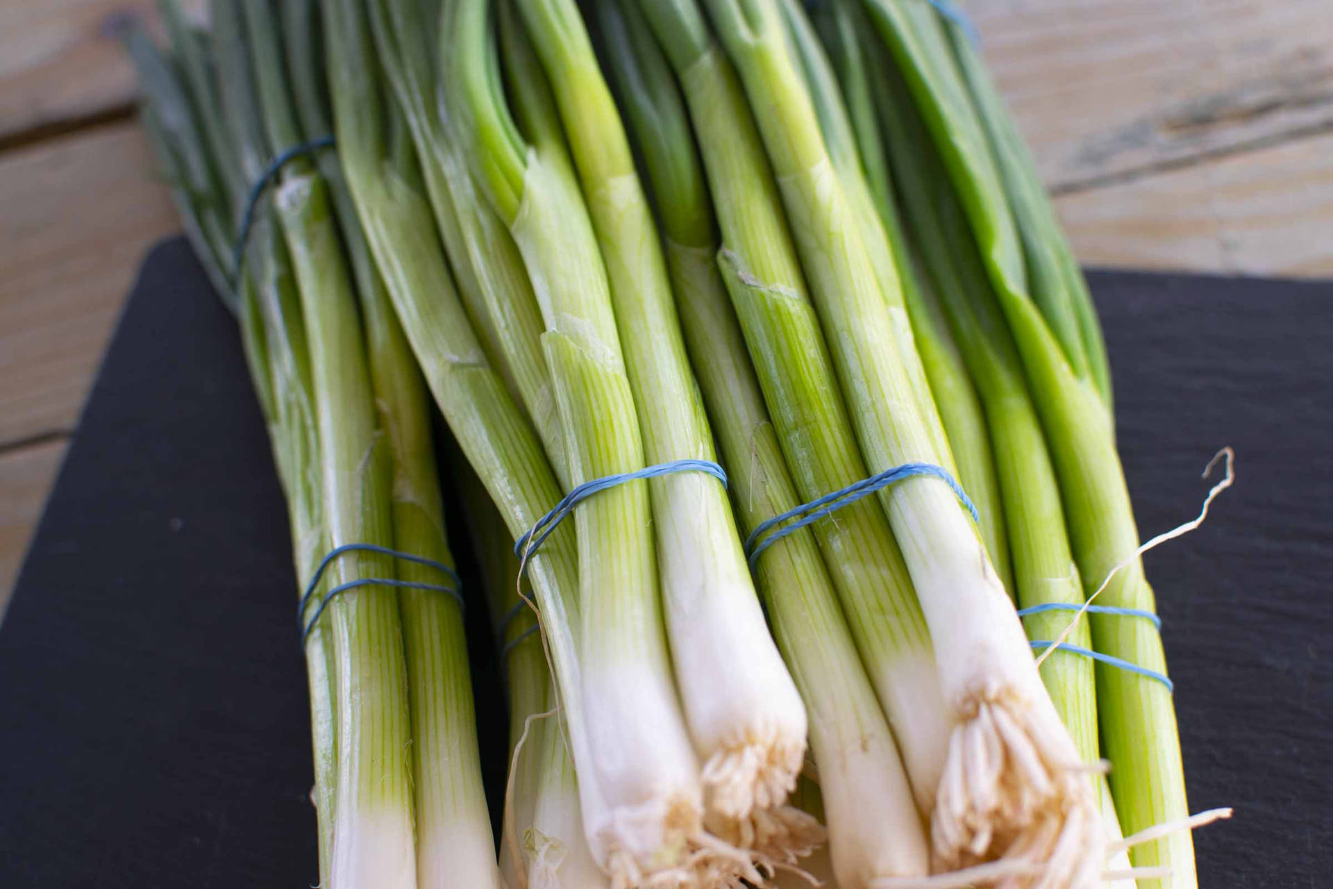 Fresh Bundle Of Spring Onions Background