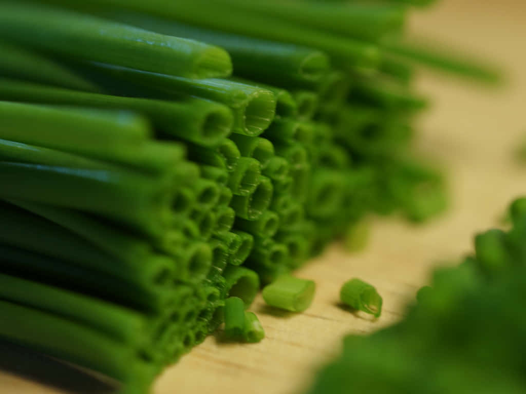 Fresh Chives Chopped On Wooden Chopping Board Background