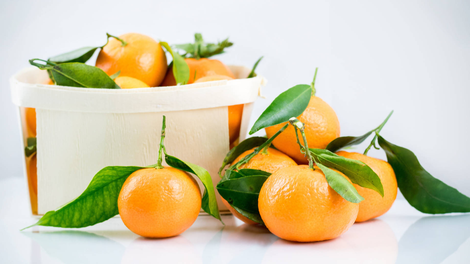 Fresh Clementine Citrus Fruits In A White Basket