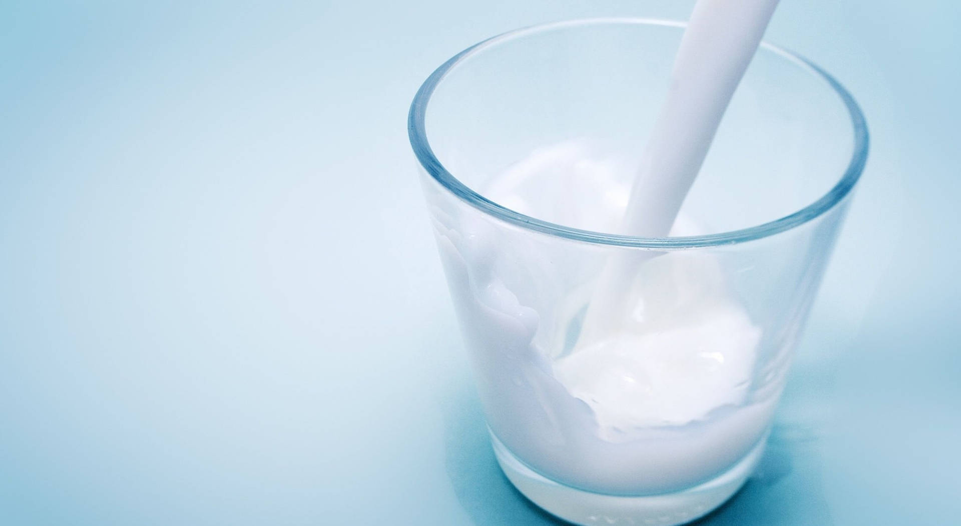 Fresh Dairy Milk Pouring Into A Glass Background