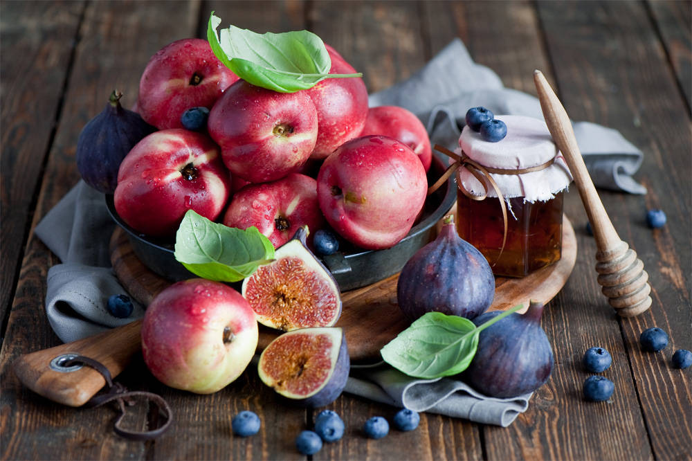 Fresh Figs, Apples And Honey On Rustic Table