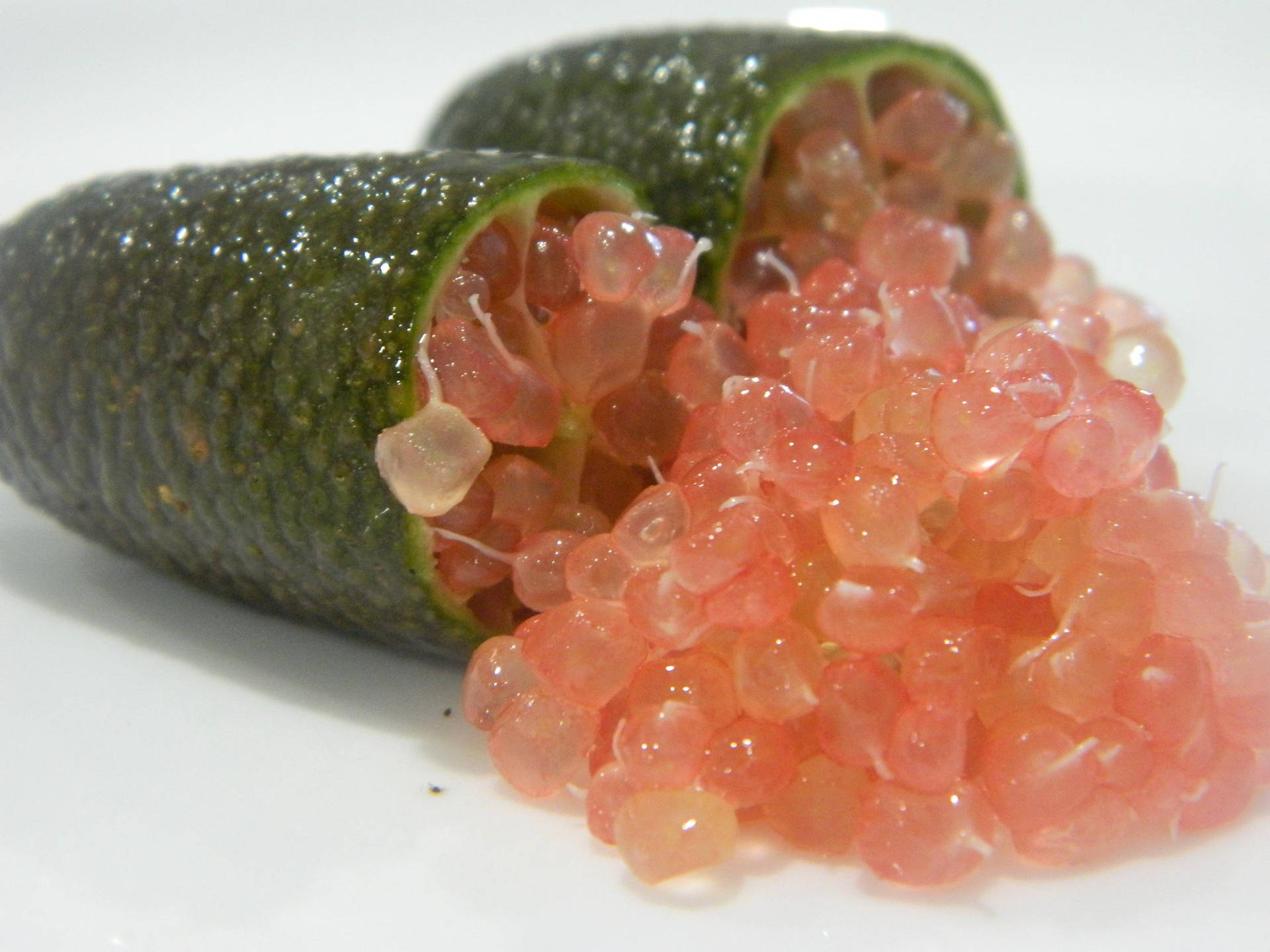 Fresh Finger Lime With Vivid Pink Insides Background