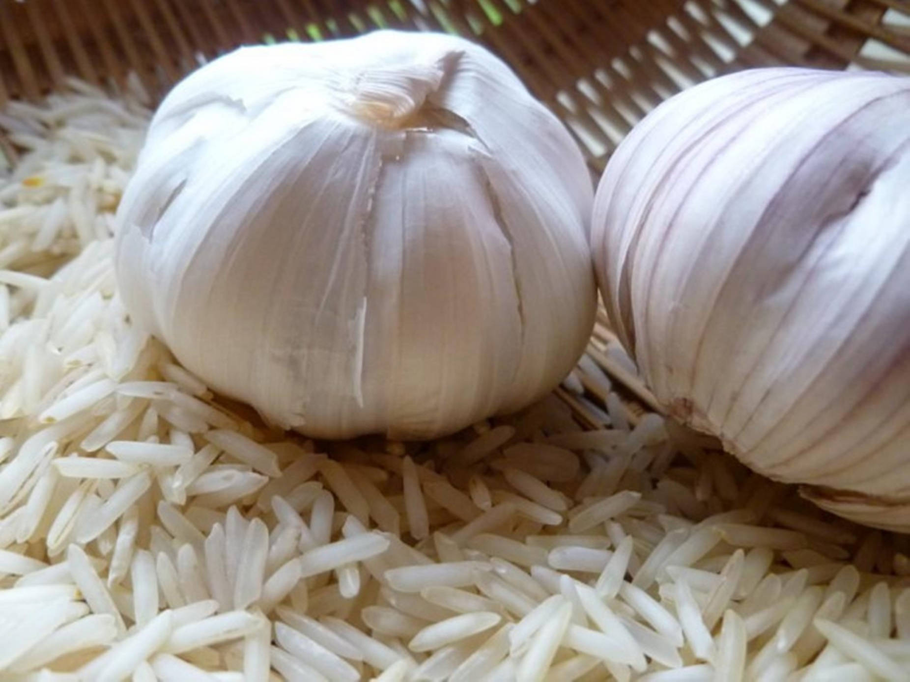 Fresh Garlic Cloves With Rice Grains Background