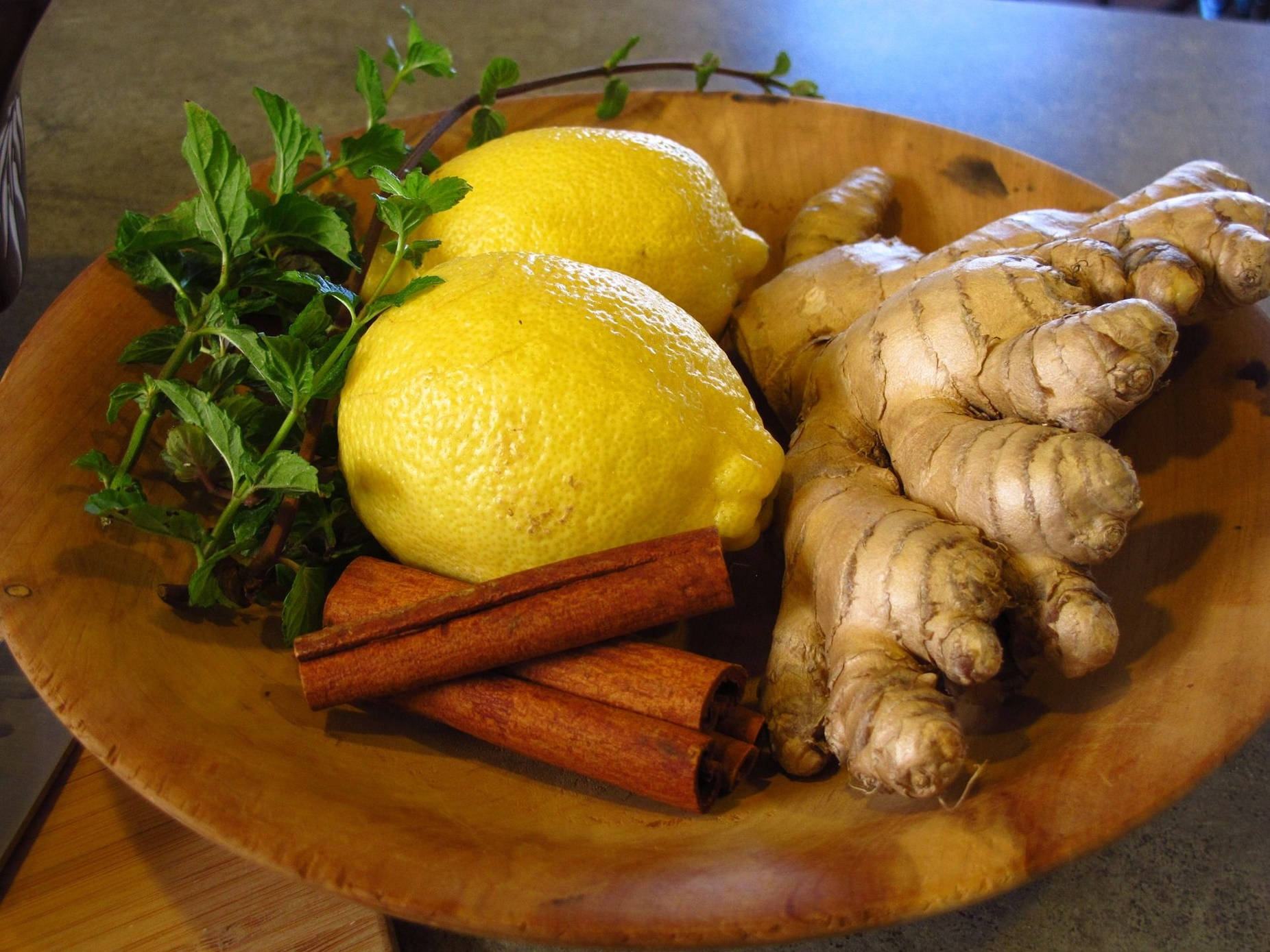 Fresh Ginger Root With Zesty Lemons And Cinnamon Sticks Background