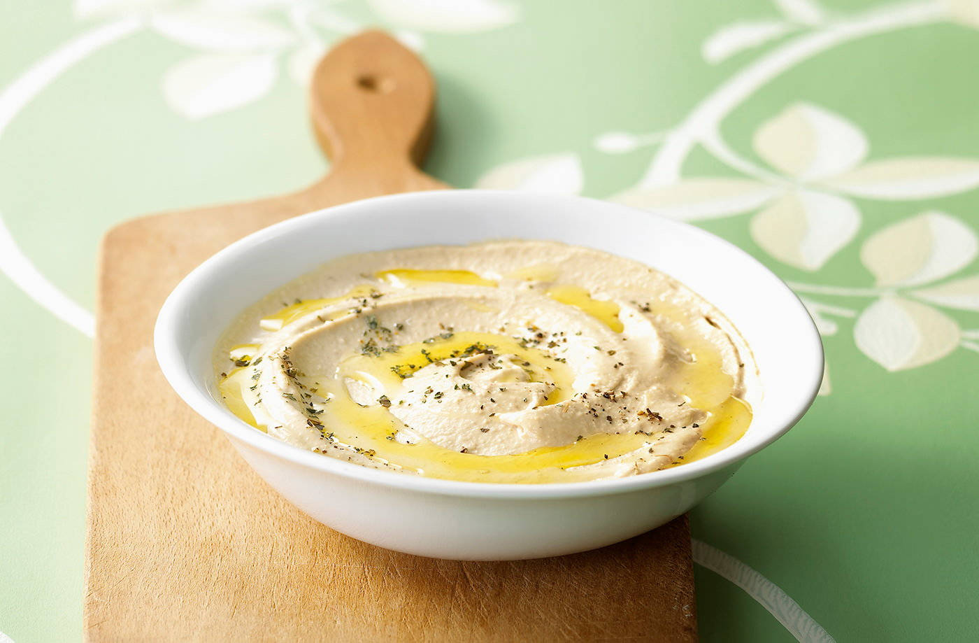 Fresh Organic Hummus On A Chopping Board Background