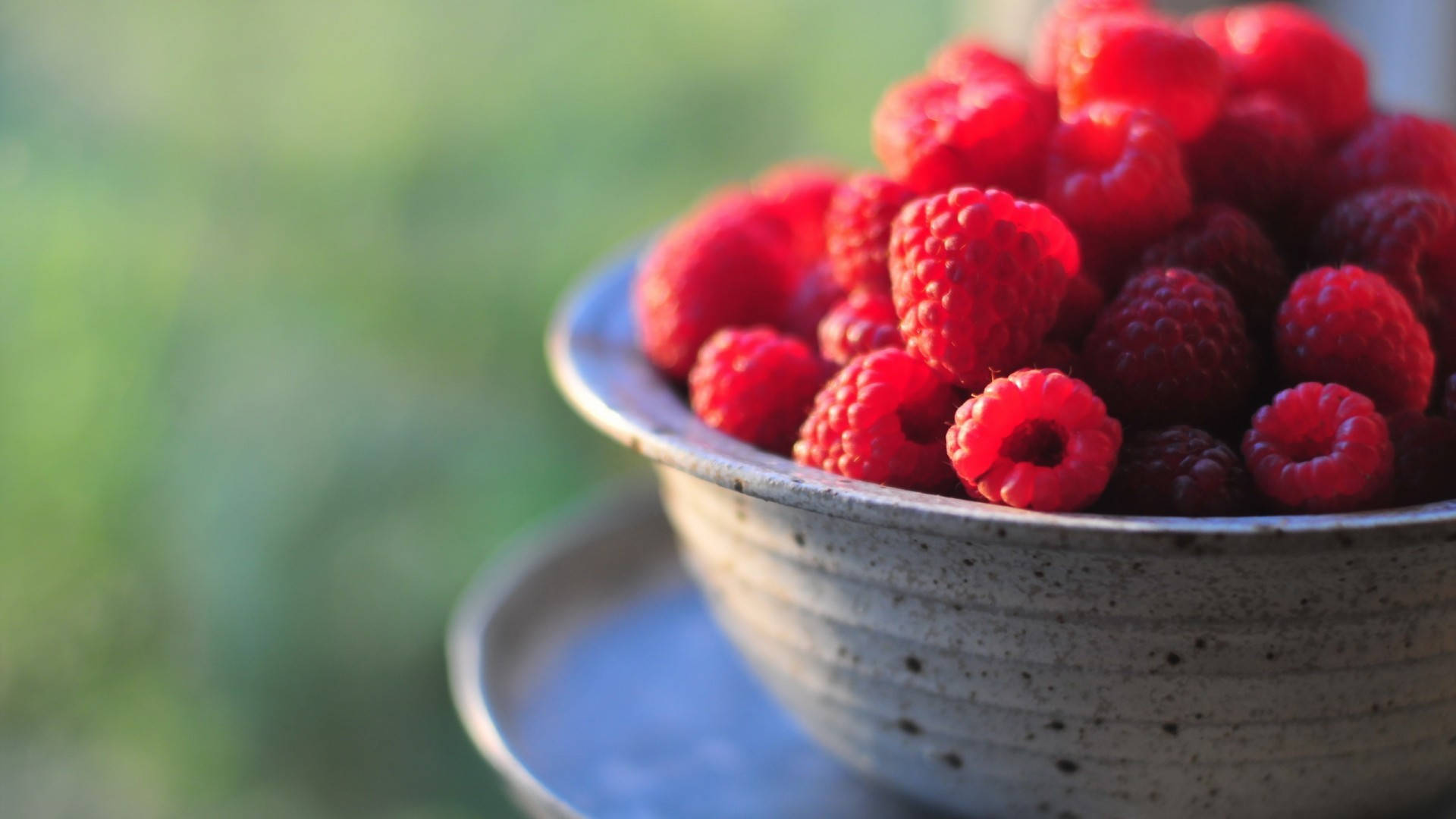Fresh Raspberries In A Stoneware Bowl Background